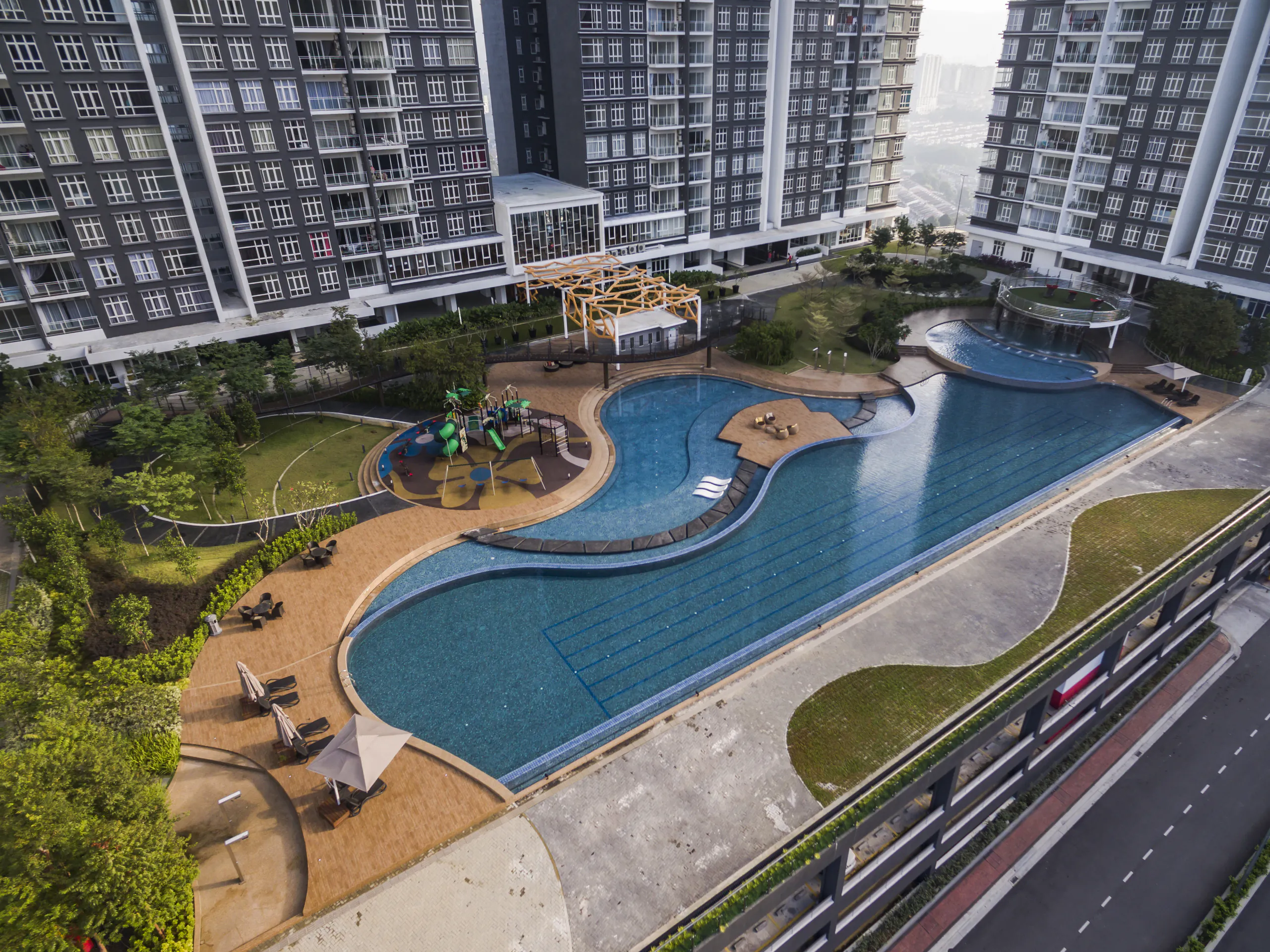 Aerial view of the lagoon pool and gardens at Foresta Residence